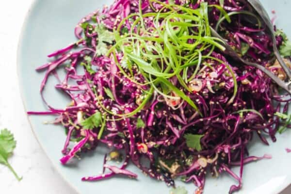 Crunchy Asian salad on a large light blue serving plate.