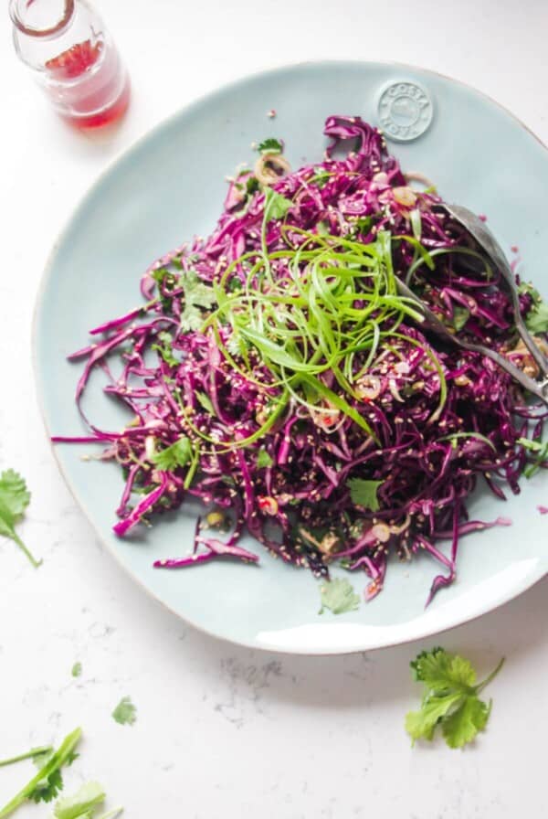 Crunchy Asian salad on a large light blue serving plate.