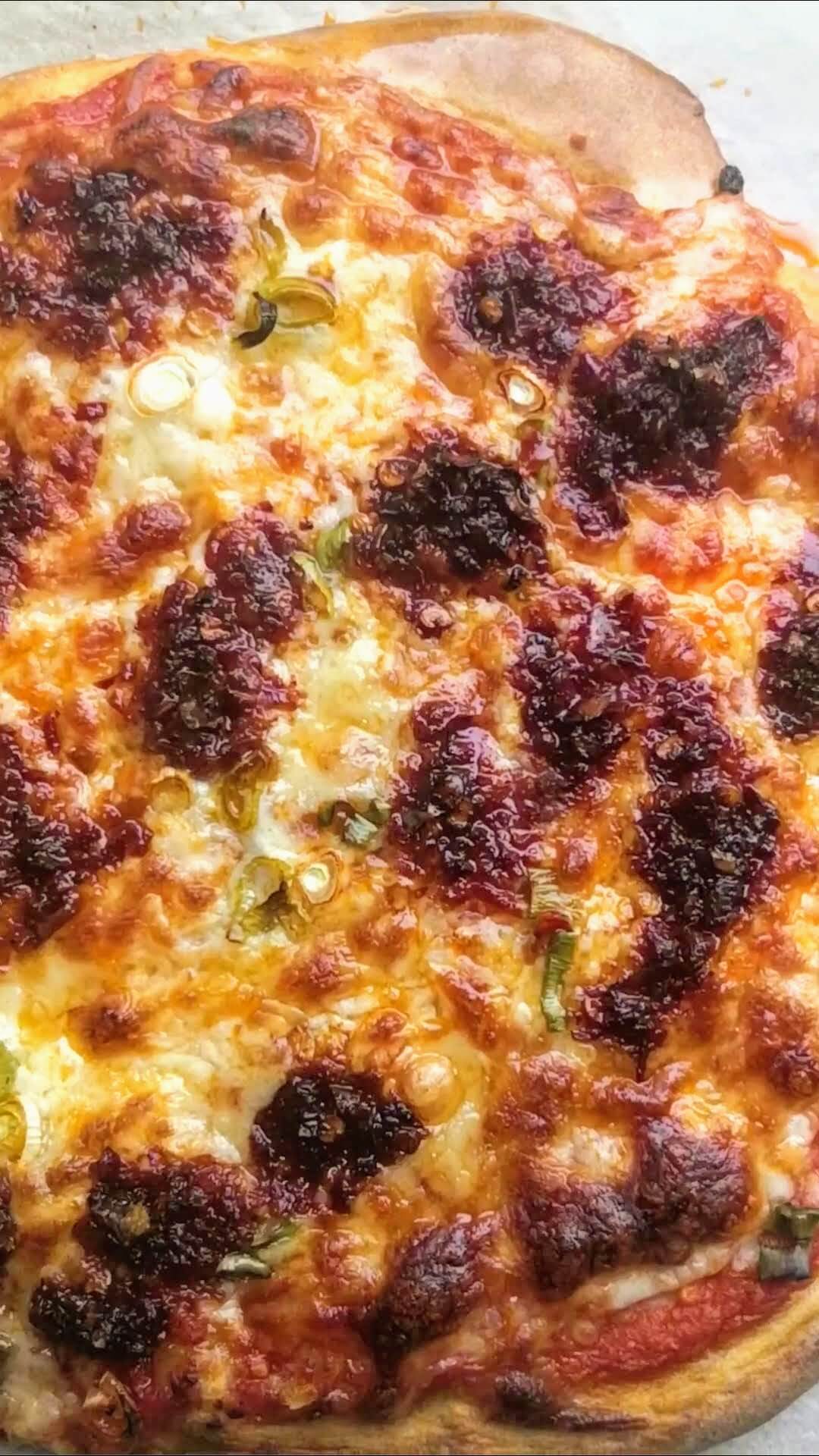 Close up of cooked 'nduja tomato pizza.