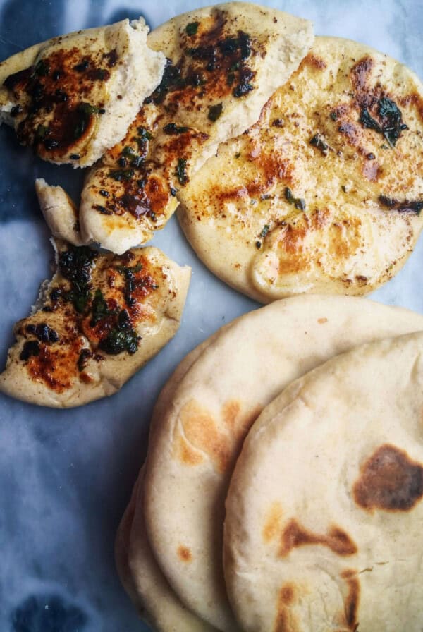 A pile of easy soft flatbreads on a grey marble background.