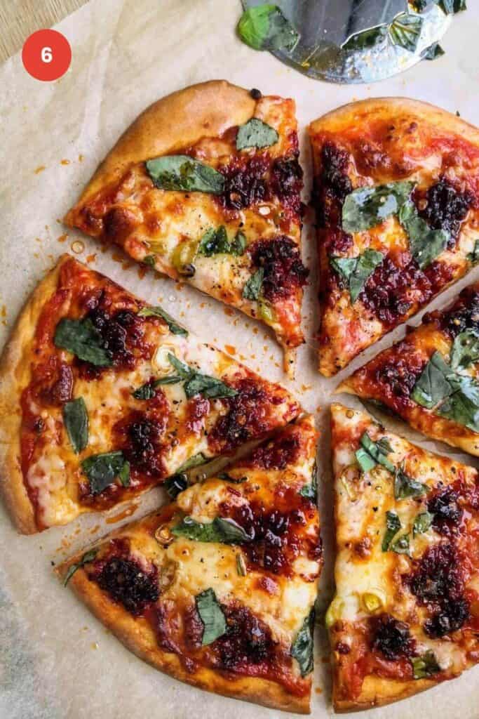 Nduja and cheese pizza baked and sliced.