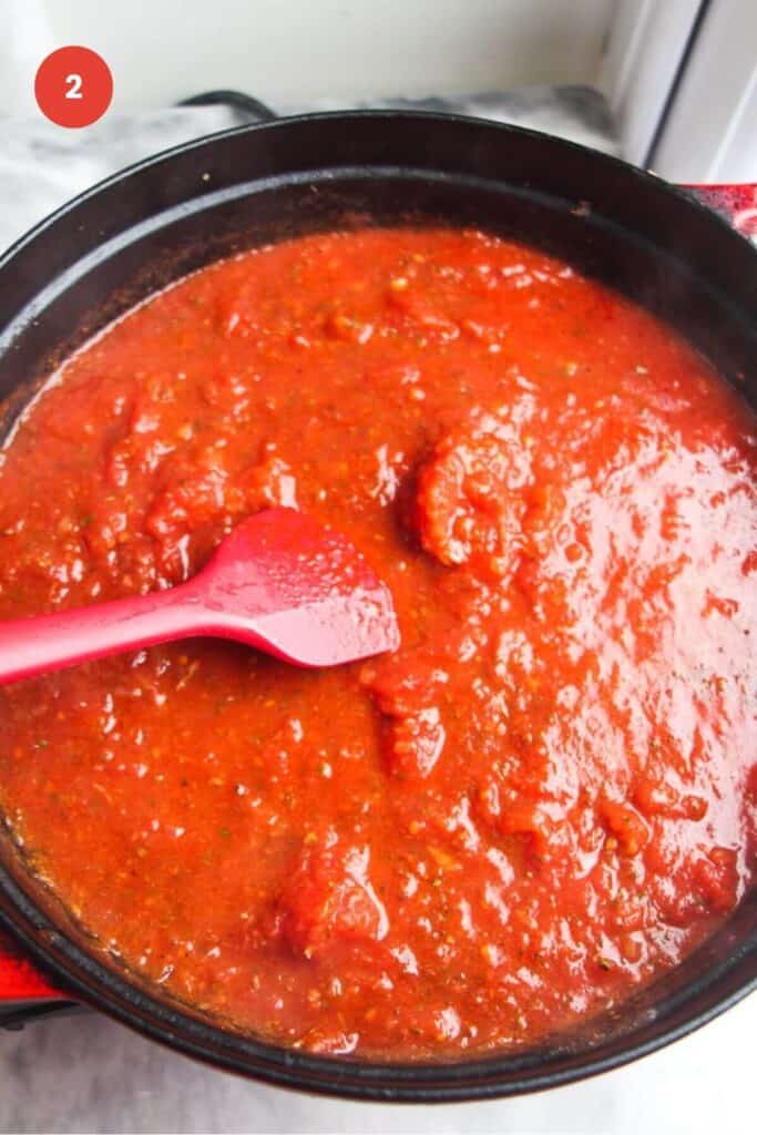 Tomato sauce simmering in a large pot.