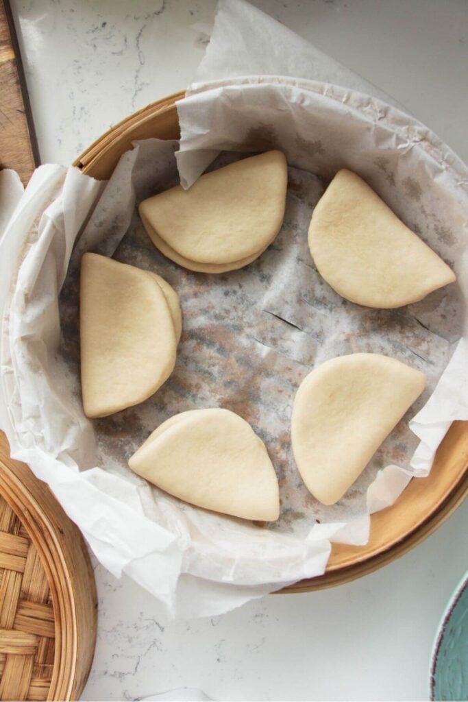 Formed bao buns in steamer.