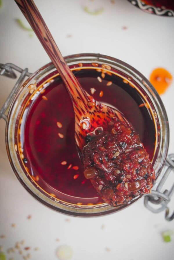Wooden spoon in a jar of chilli oil.