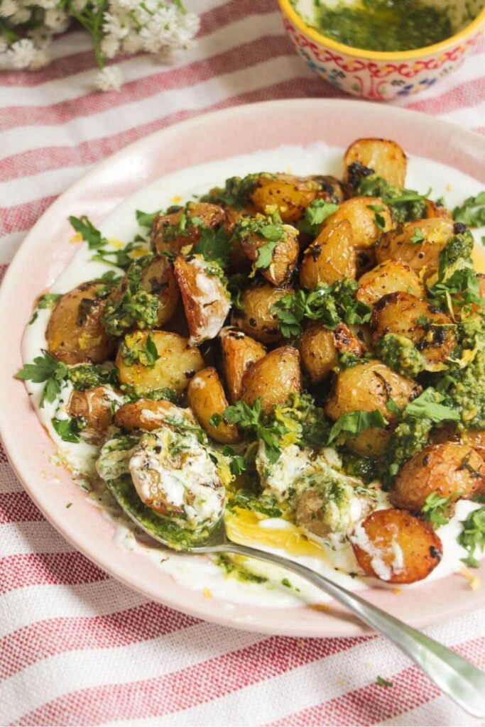 Garlic butter potatoes on top of creamy whipped feta and topped with pesto.