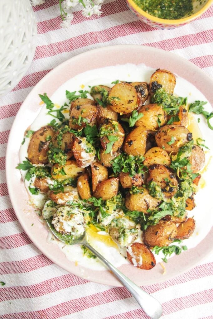 Garlic butter potatoes on top of creamy whipped feta and topped with pesto.