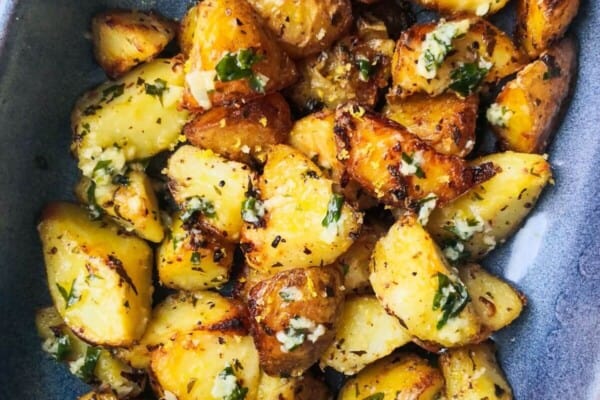 Garlic butter potatoes in a small blue oven dish.