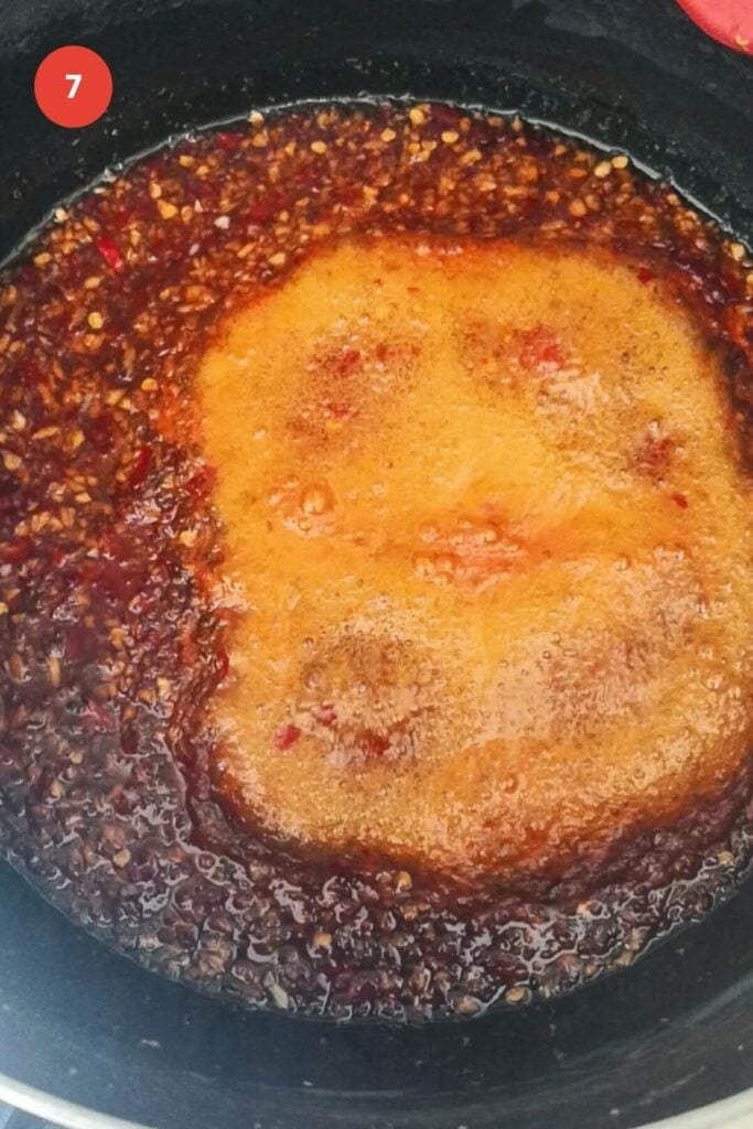 Chili jam bubbling in large pot.