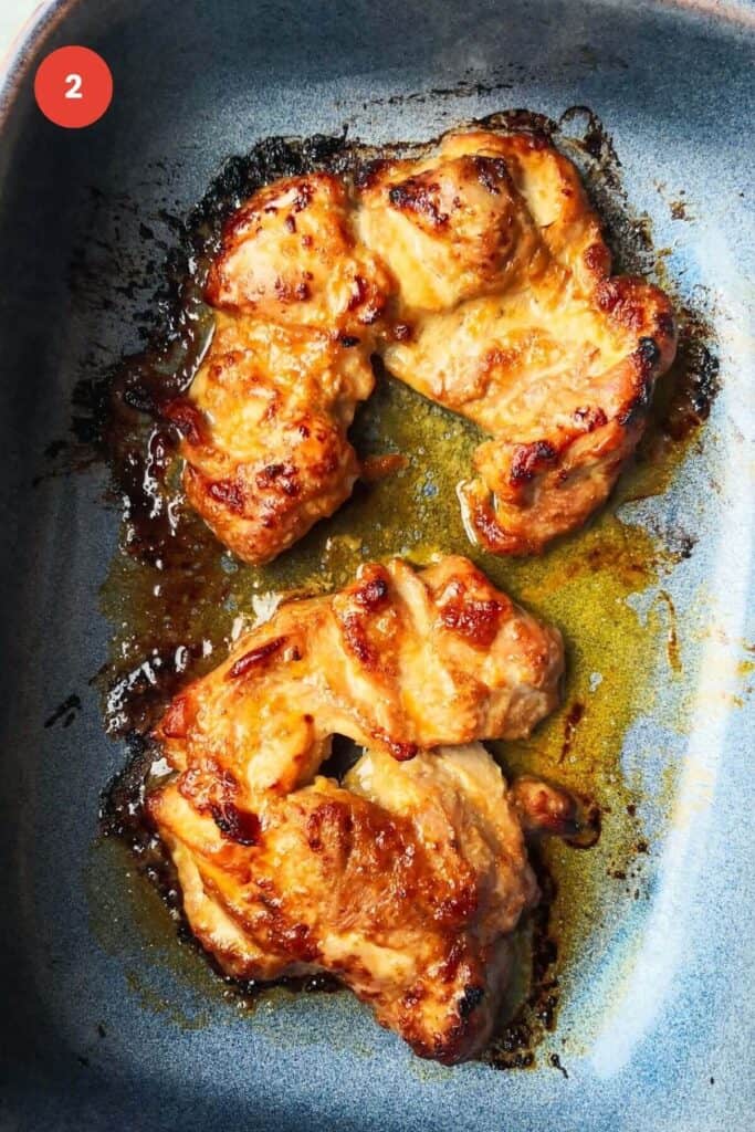 Cooked miso chicken thighs in an oven dish.