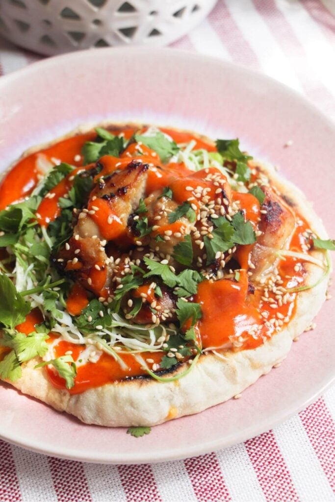 Miso grilled chicken on a flatbread with gochujang aioli.