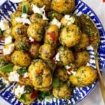 Pesto potato salad with burrata in a bowl.