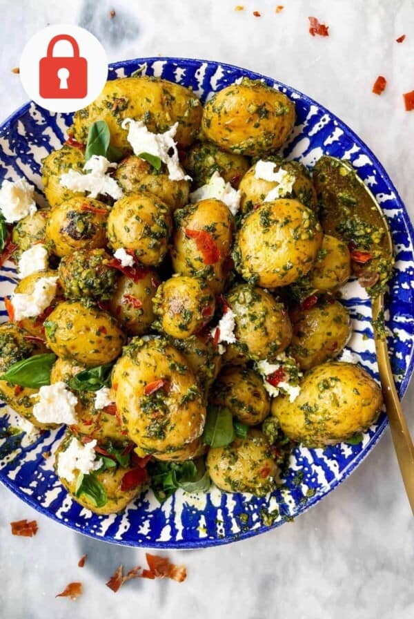 Pesto potato salad with burrata in a bowl.