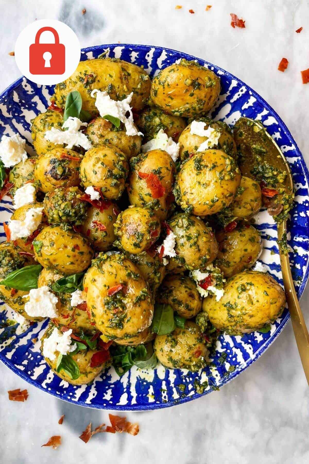 Pesto potato salad with burrata in a bowl.