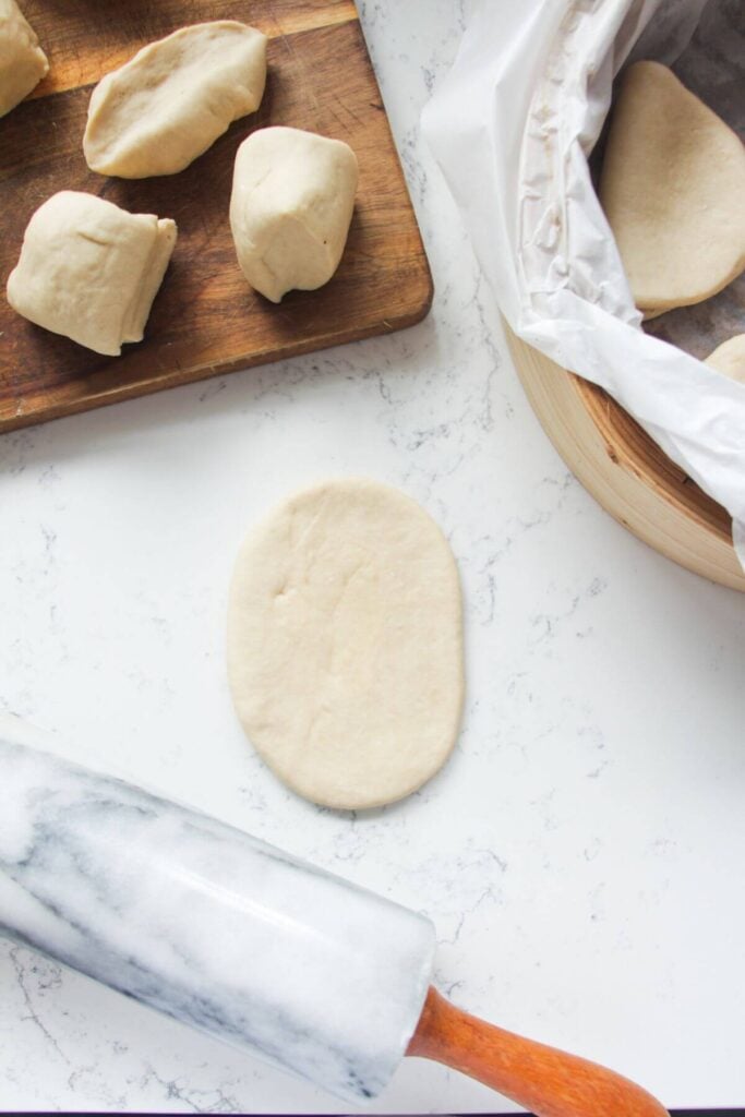 Oval of bao dough rolled out.