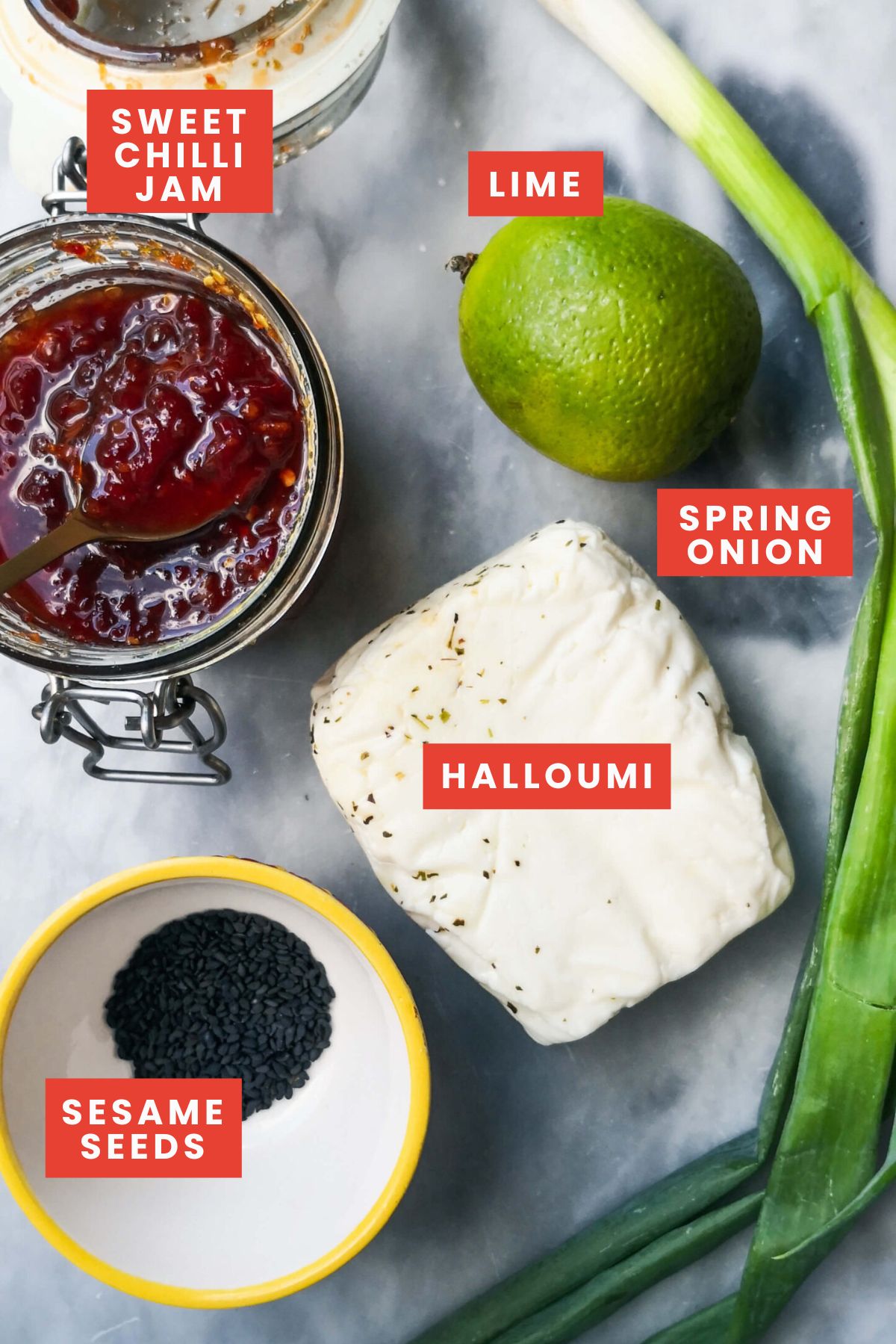 Ingredients for sweet chilli halloumi on a grey marble background.