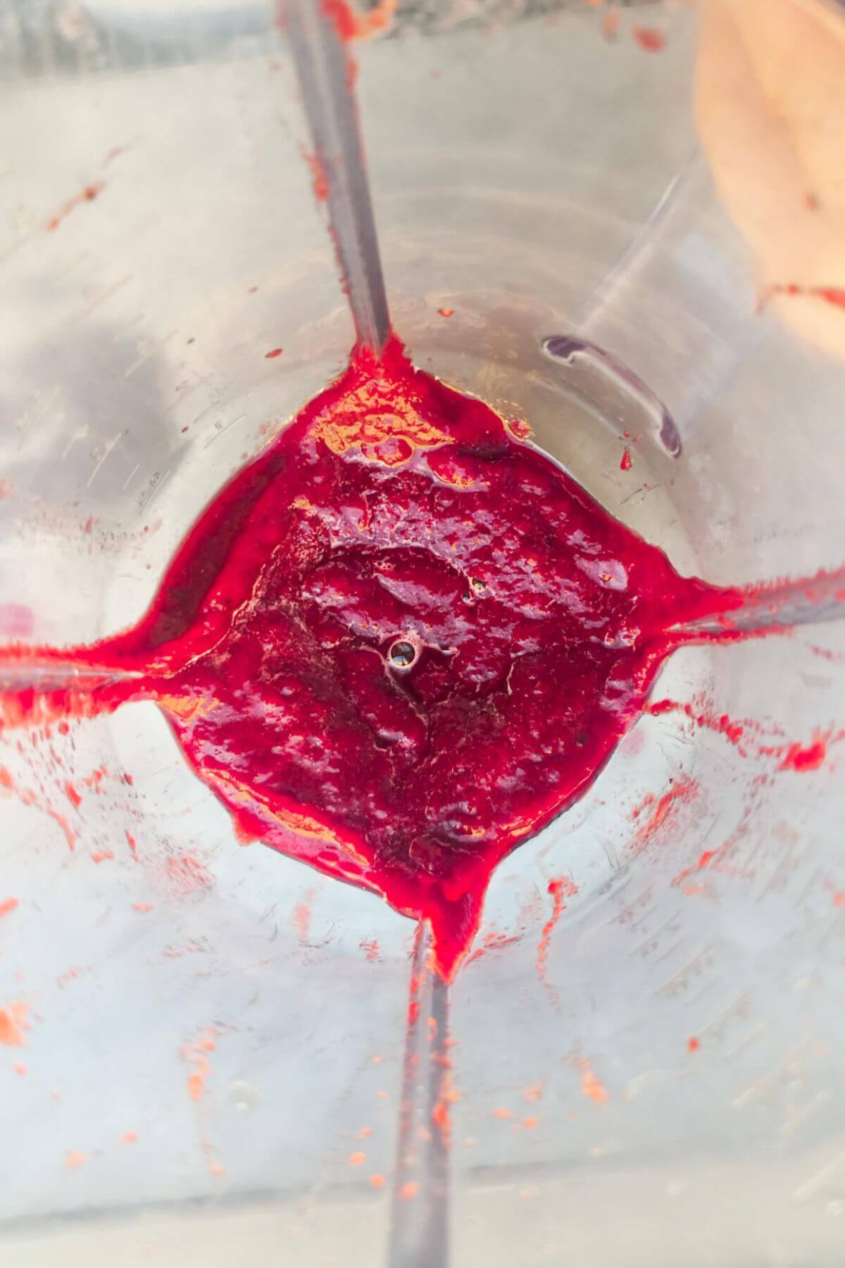 Bright pink beetroot puree in a blender.