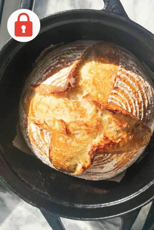 Golden baked bread in a black cast iron pot.