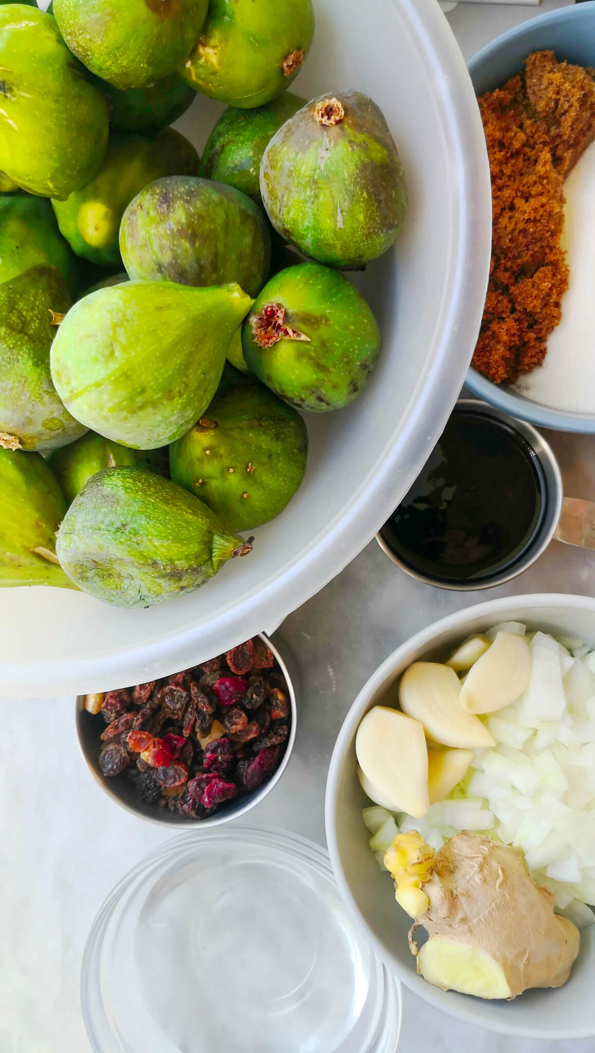 Ingredients for fig chutney laid out on a marble board.