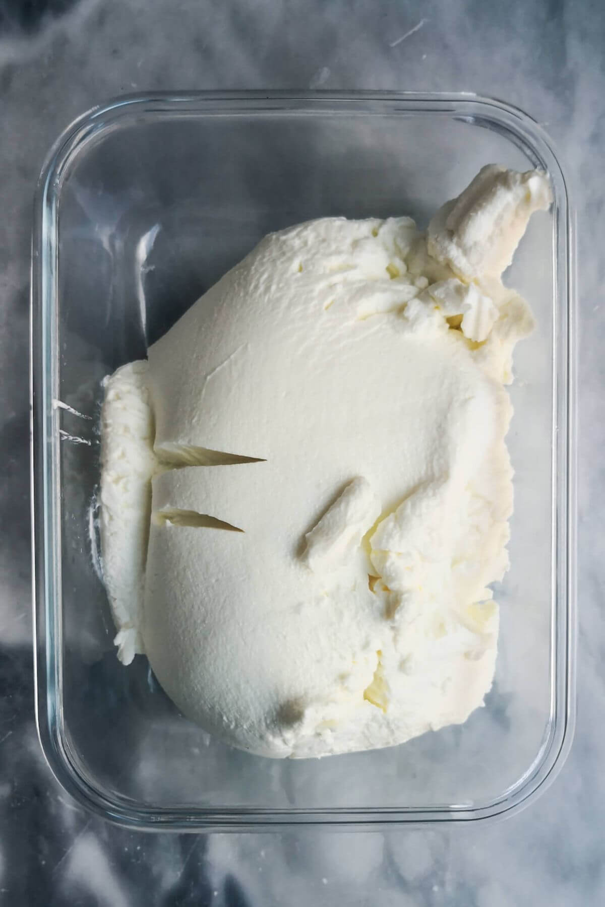 Labneh after straining in a glass container.
