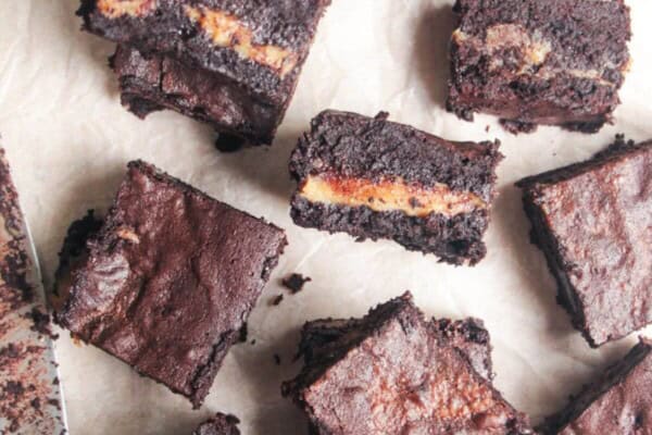 Sliced salted caramel brownies on baking paper.