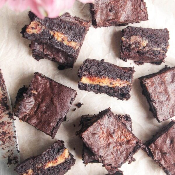 Sliced salted caramel brownies on baking paper.