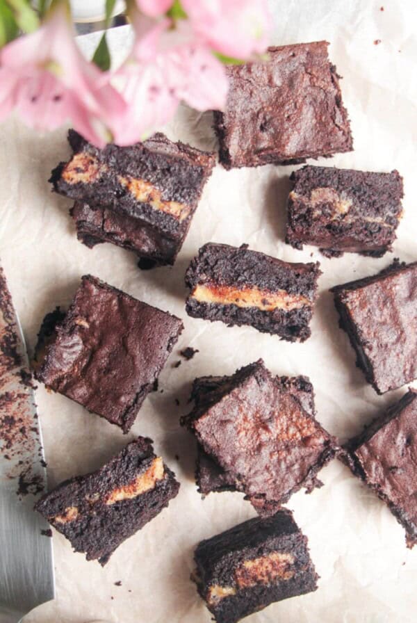 Sliced salted caramel brownies on baking paper.