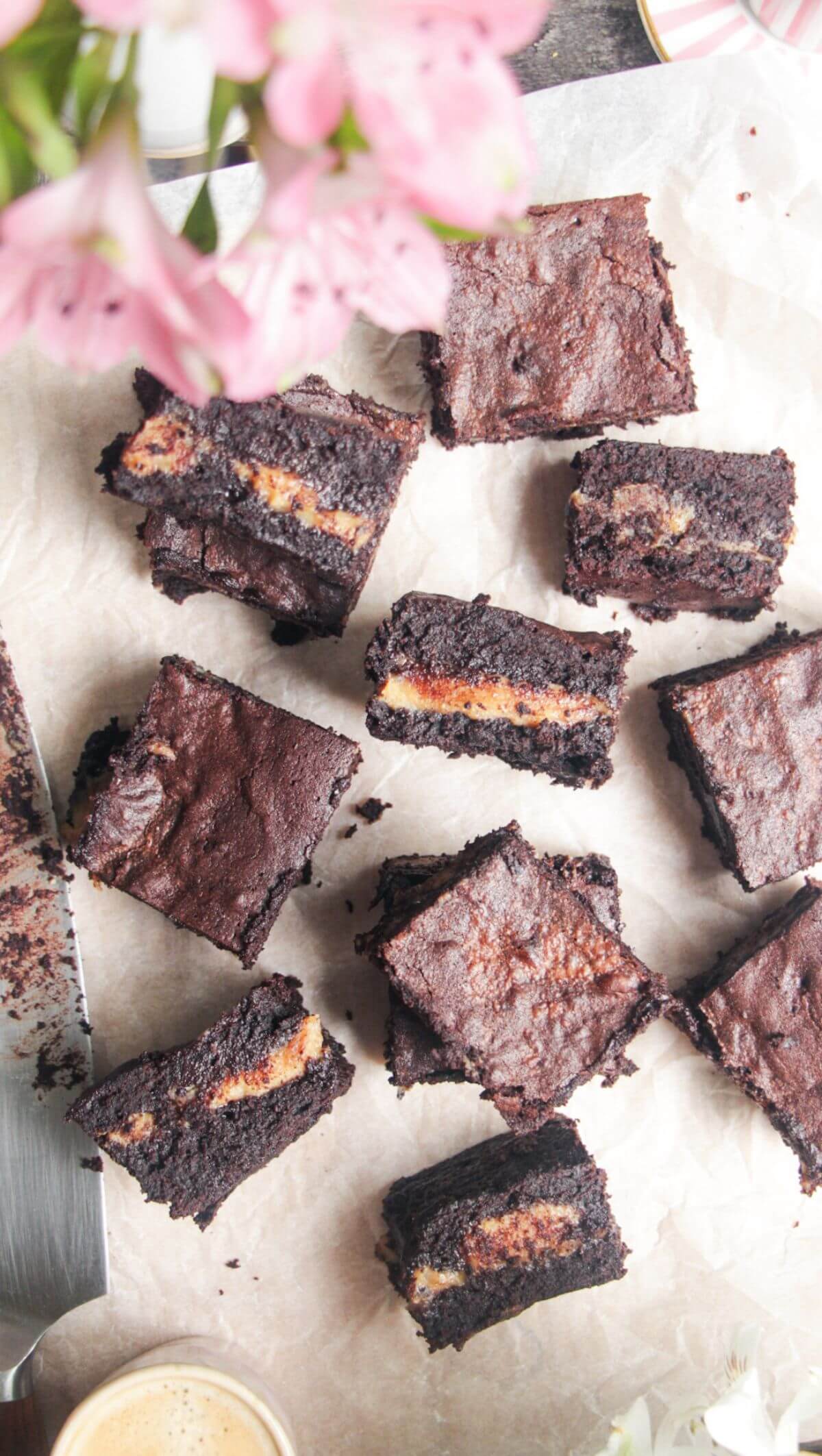 Sliced salted caramel brownies on baking paper.
