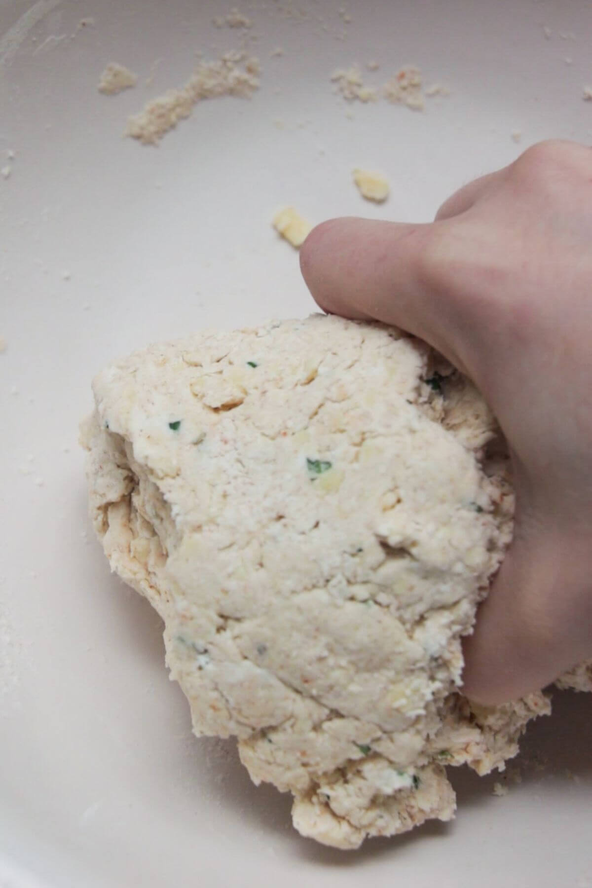 Hand forming cheese scone dough.