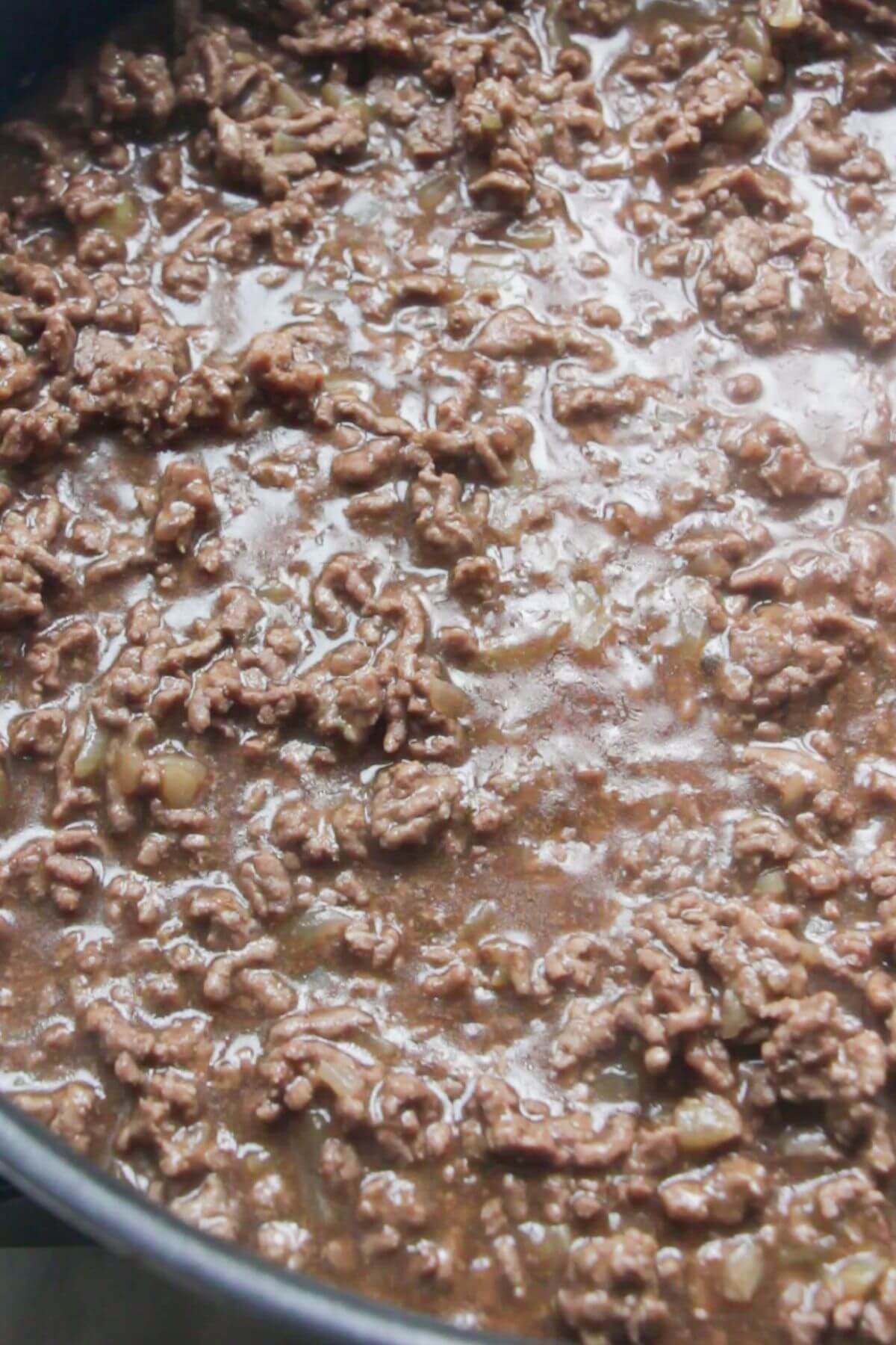 Close up of thickened beef mince gravy in a large pan.