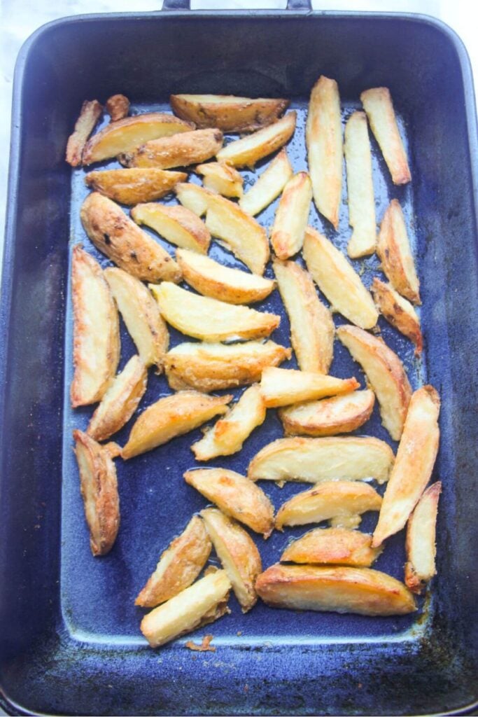 Crispy cooked wedges in a blue oven dish.