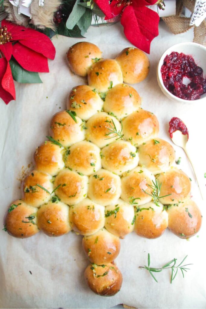 Garlic butter glazed Christmas tree dough balls with cranberry sauce on the side.