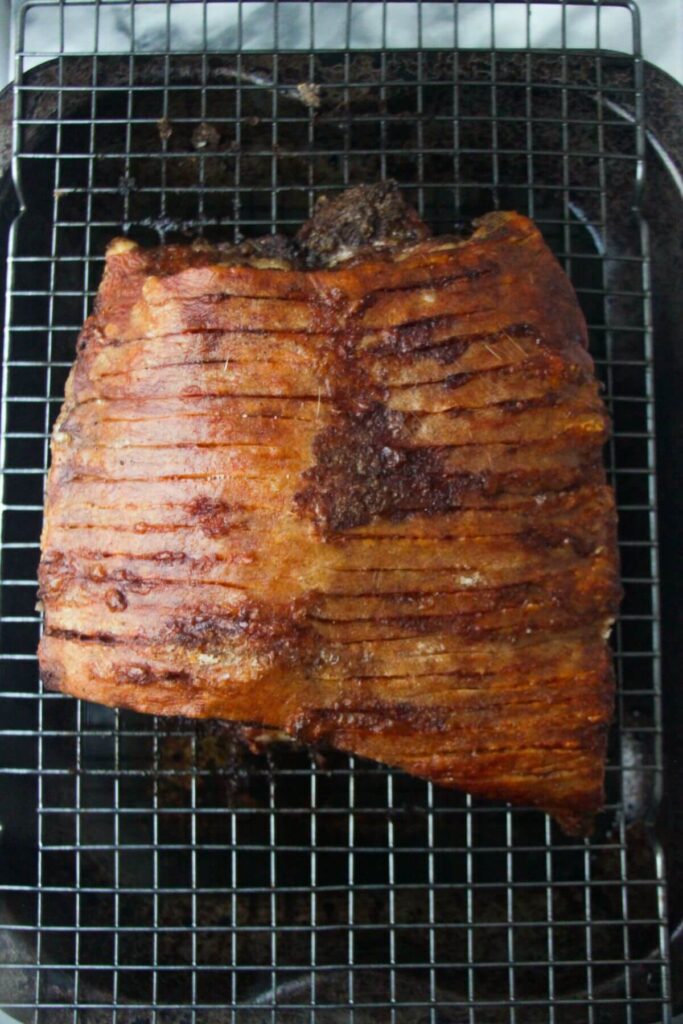 Crispy pork belly after being cooked, on a wire rack.
