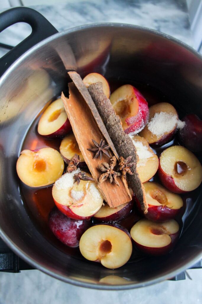 Ingredients for sticky plum sauce in a small silver pot.