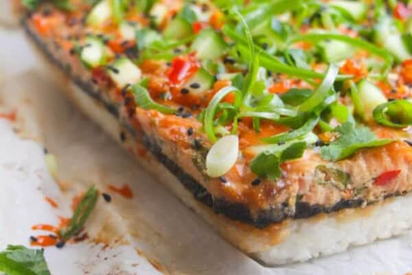 Salmon sushi bake on a baking paper lined tray.