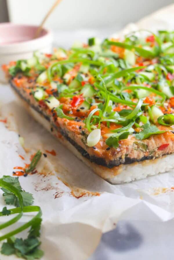 Salmon sushi bake on a baking paper lined tray.