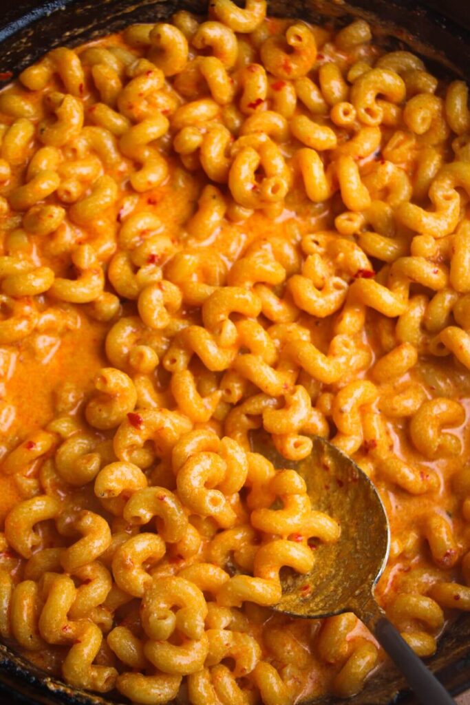 Close up of spicy mac and cheese in a large black skillet.