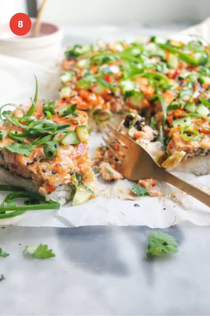 Salmon sushi bake sliced with a fork.
