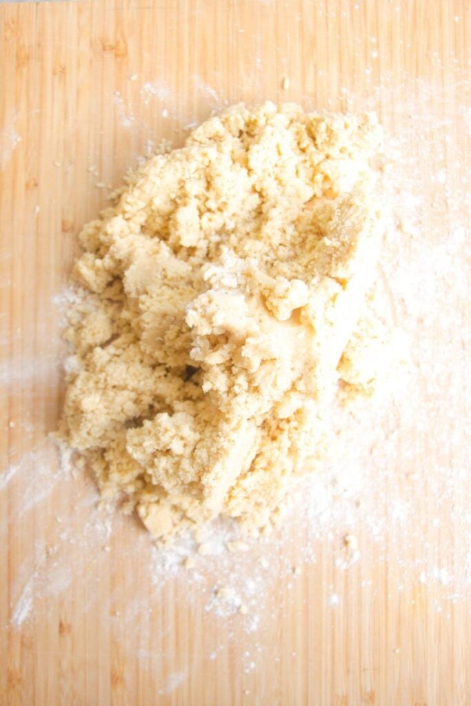 Blitzed pastry laid out on a wooden board.