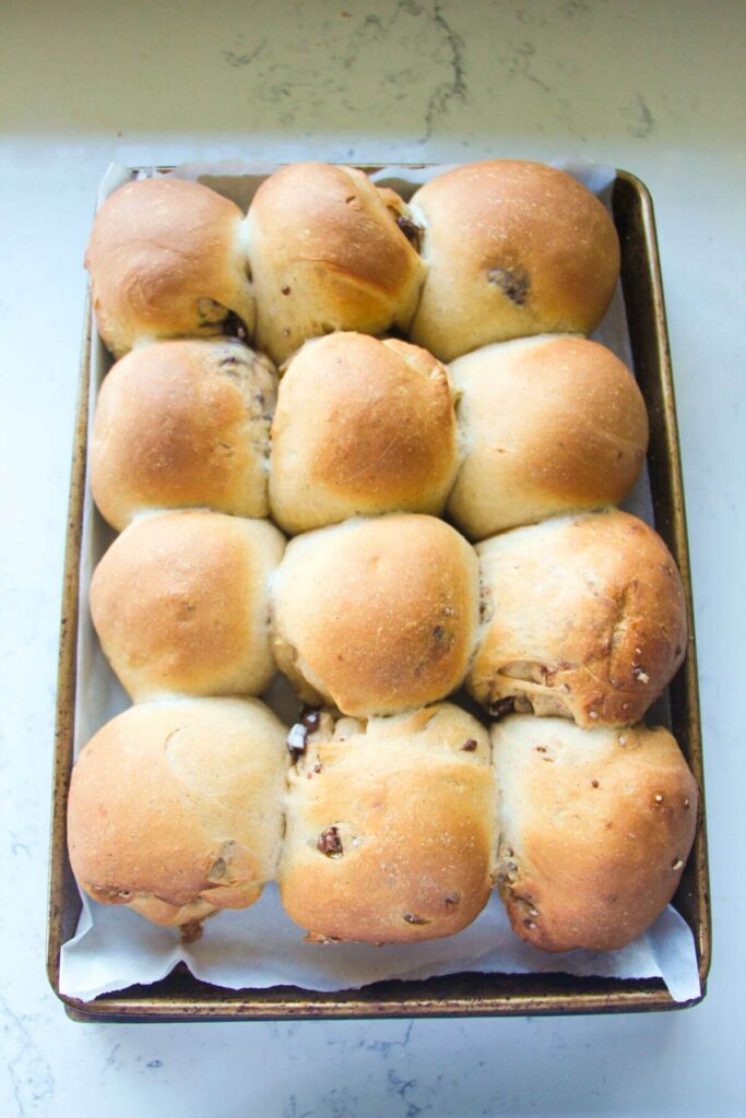 12 mini egg hot cross buns, par-baked in a lined oven tray.