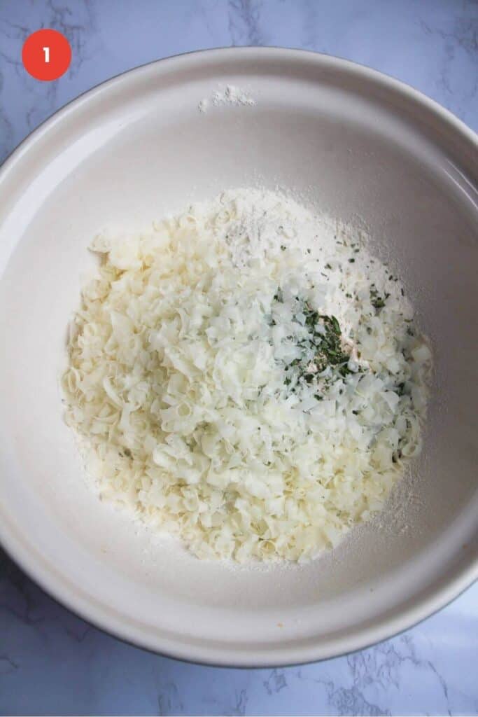 Ingredients for rosemary parmesan bread in mixing bowl.