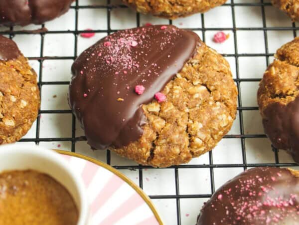 Chocolate dipped Anzac biscuits with coffee on the side.