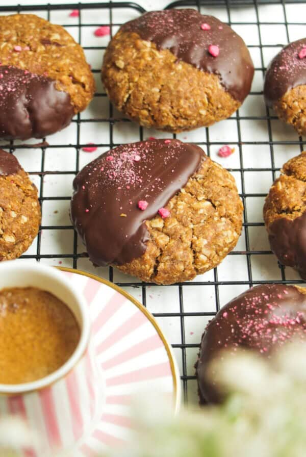 Chocolate dipped Anzac biscuits with coffee on the side.