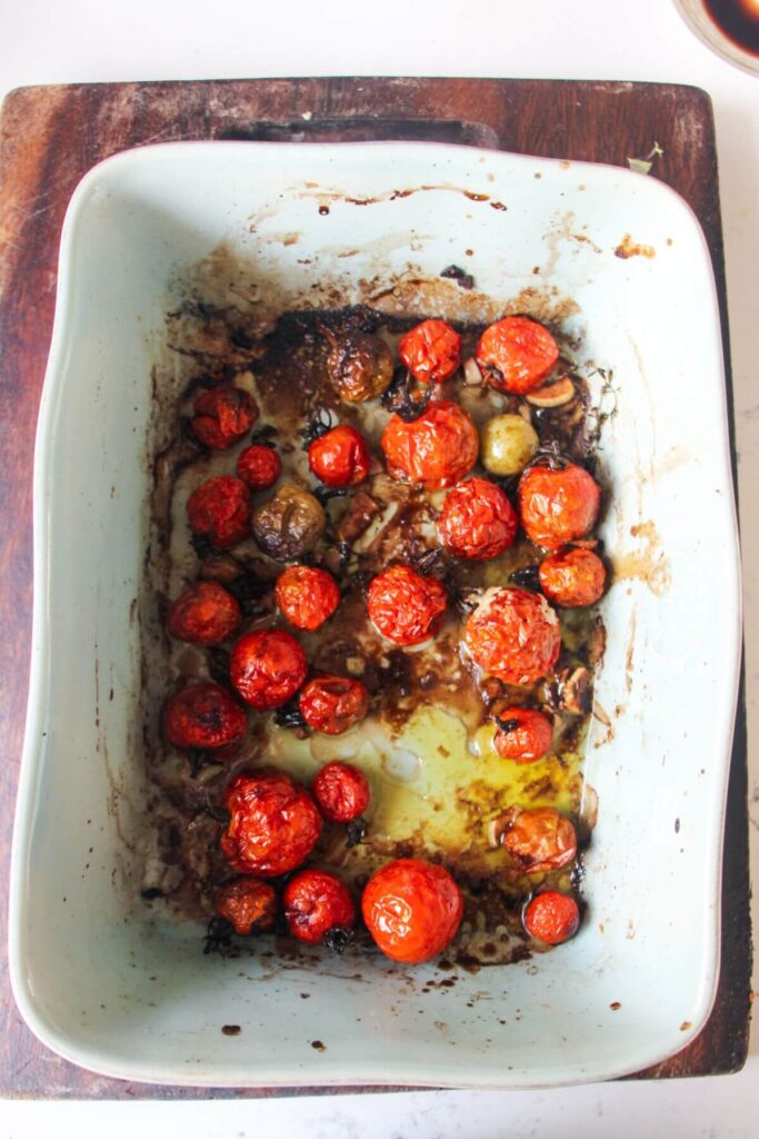 Roasted cherry tomatoes in a small blue dish.