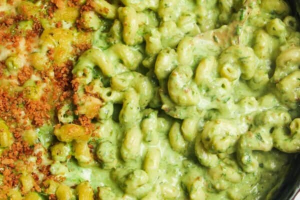 Gold spoon inside gooey green wild garlic mac and cheese.