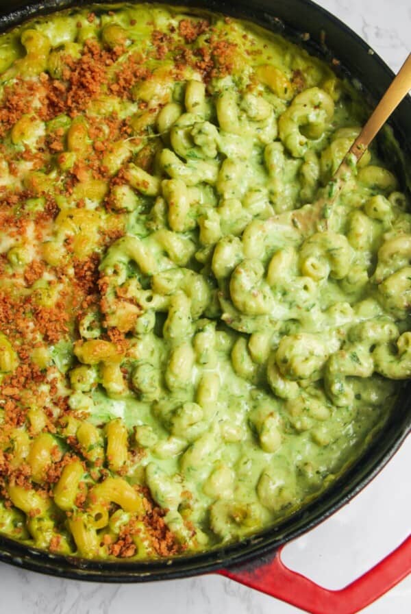 Gold spoon inside gooey green wild garlic mac and cheese.