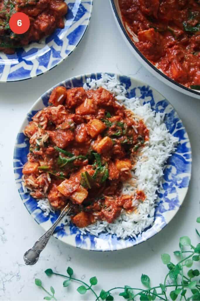 Halloumi curry served over rice with a fork.