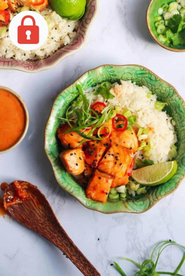 Crispy salmon bites on top of rice, with lime and cilantro.
