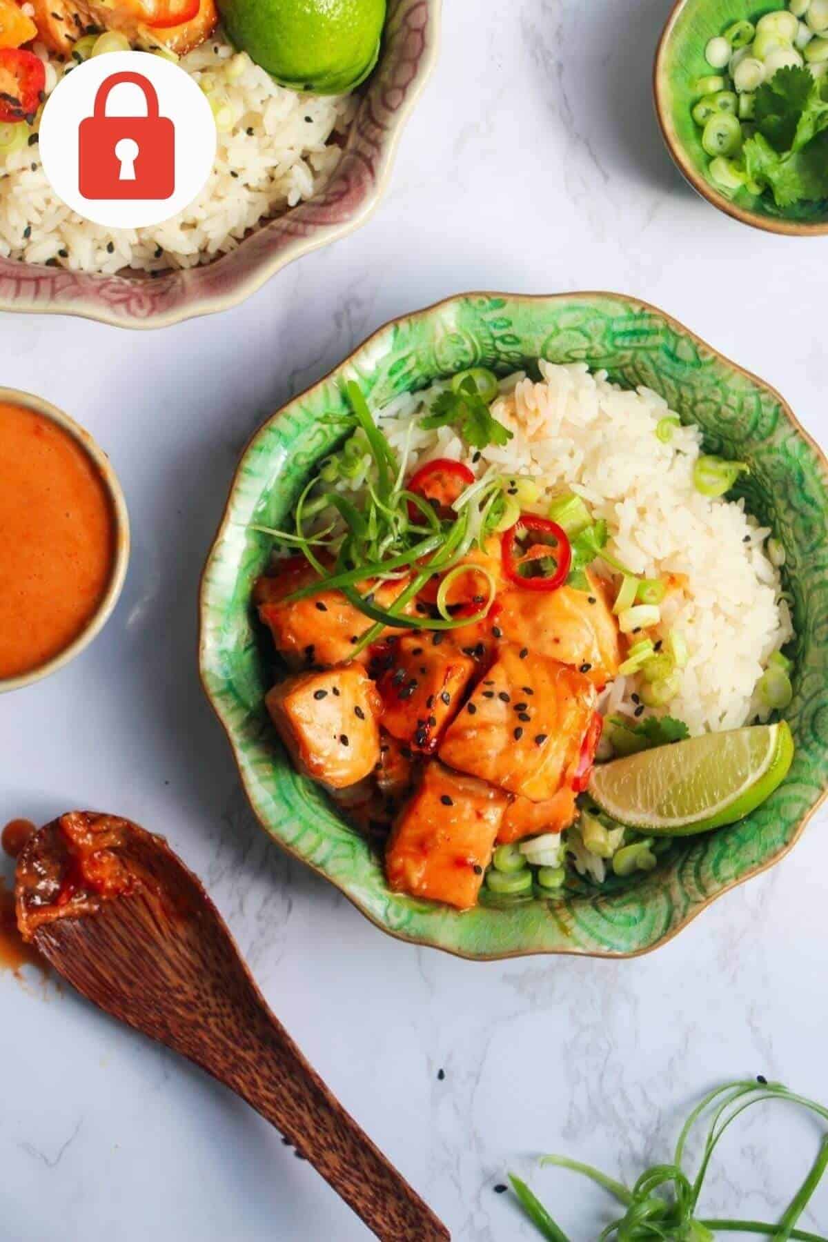 Crispy salmon bites on top of rice, with lime and cilantro.