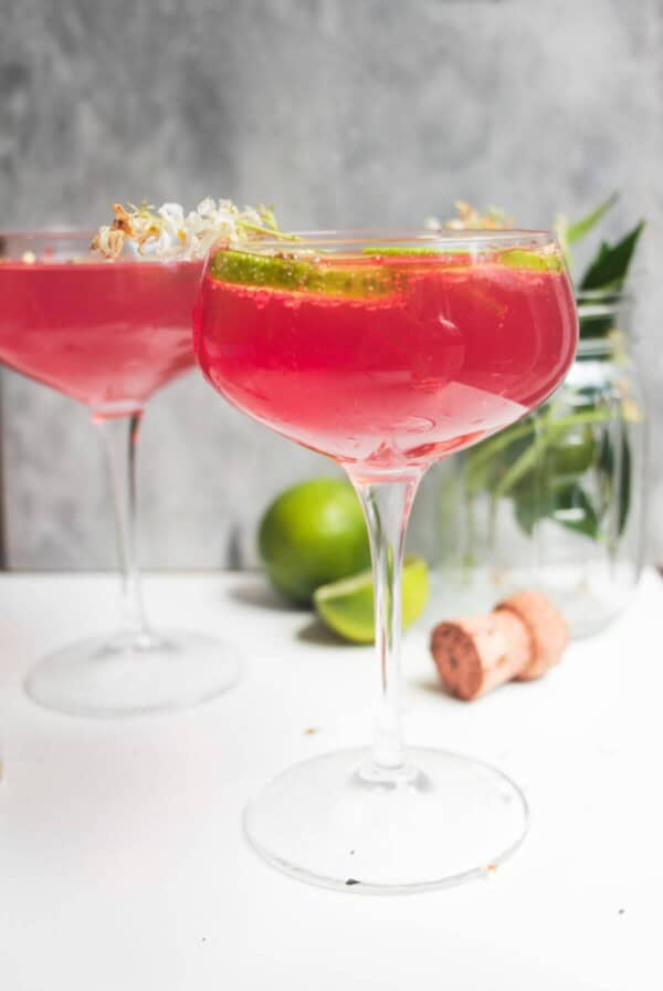 Pink Barbie spritz in a glass coupe, with another glass in the background.