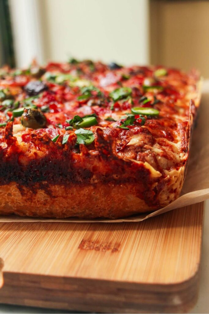 Close up of focaccia pizza with crispy cheesy crust.